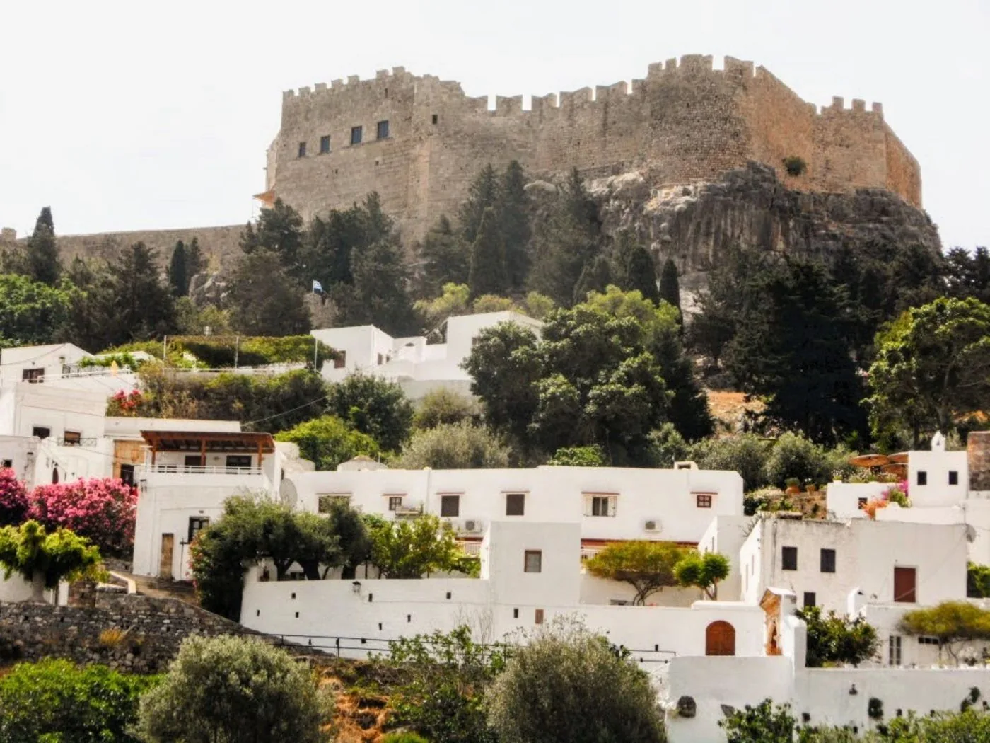 Whitewashed houses in Lindos on Rhodes below the stone walls of the Lindos Acropolis