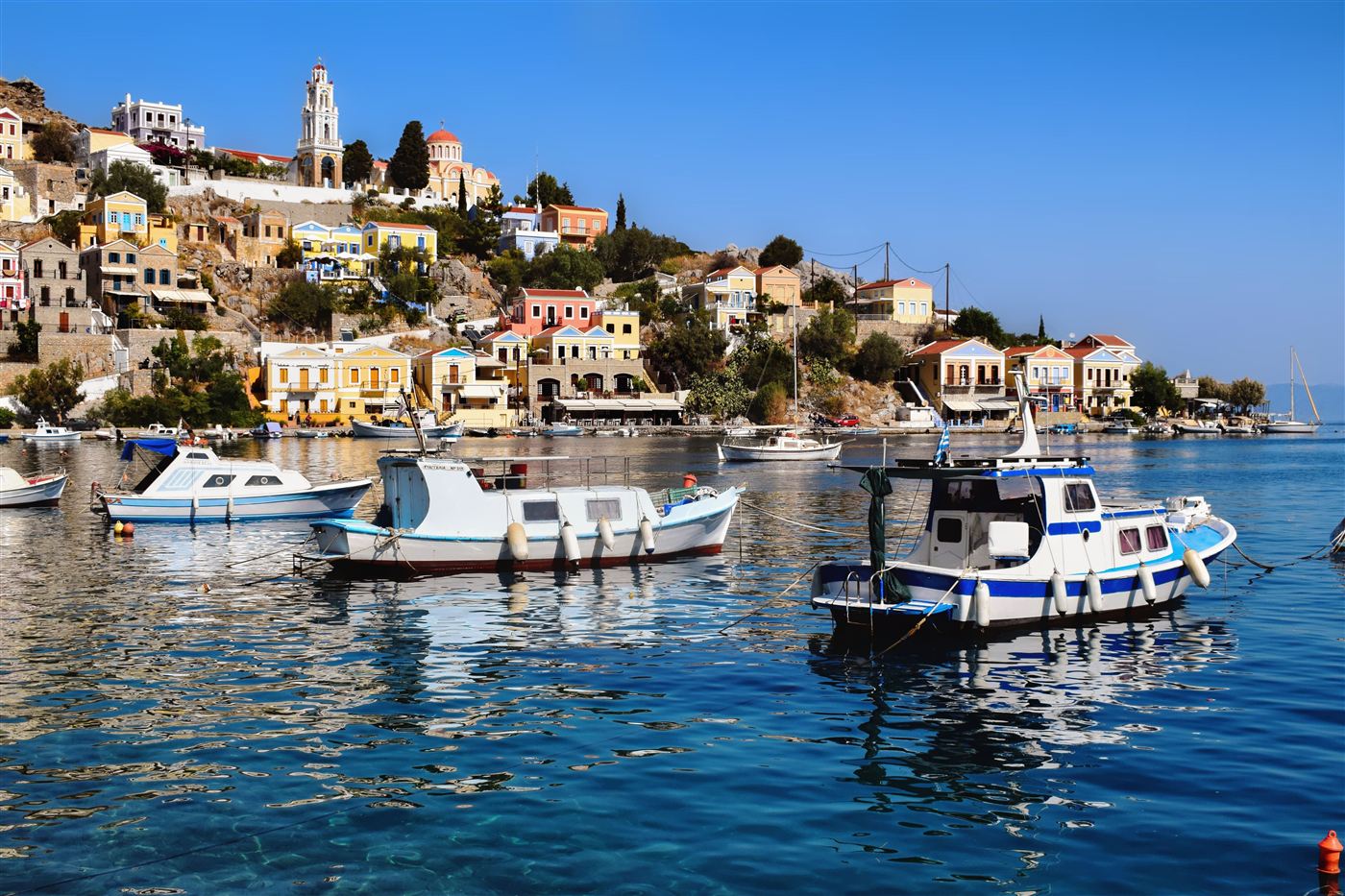 Symi harbour with pastel-colored houses